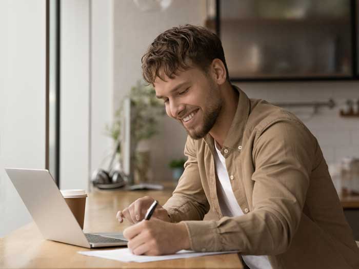 Young man prepares answers to typical interview questions. Shutterstock.com/fizkes