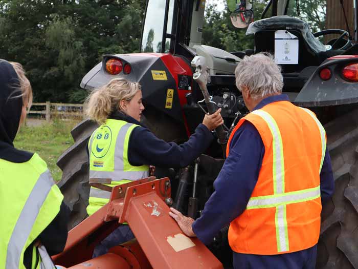 Roger Madge watches Karn Duvalier work a pto in a tractor training course at Harper Adams University.